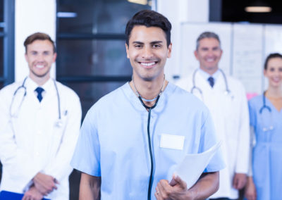 Portrait of medical team standing together and smiling in hospital